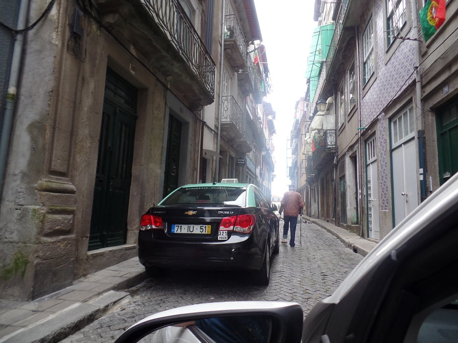 Dirigindo nas ruas antigas e estreitas nos centros históricos de Portugal